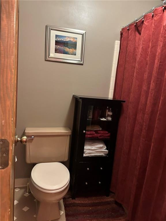 bathroom featuring tile patterned flooring and toilet