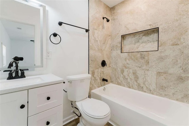 full bathroom featuring vanity, toilet, and tiled shower / bath combo