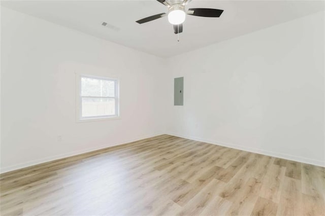 spare room with electric panel, light hardwood / wood-style flooring, and ceiling fan