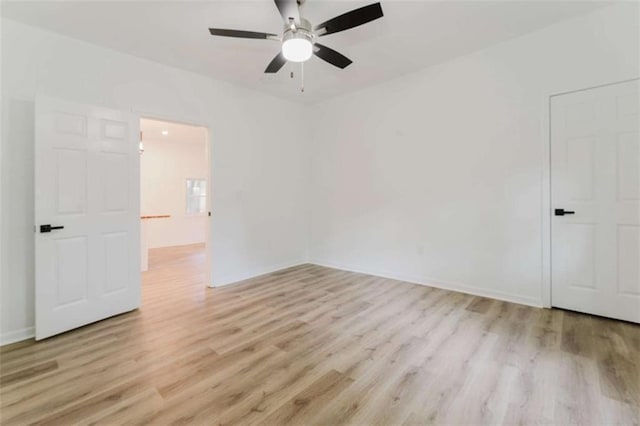 spare room with light hardwood / wood-style floors and ceiling fan