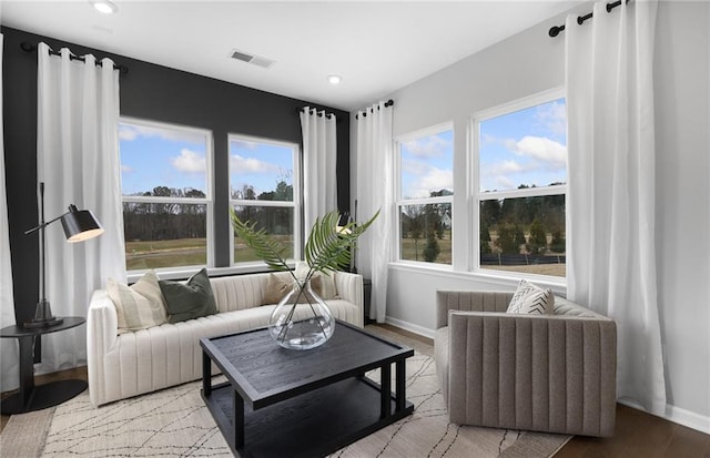 living area featuring baseboards, visible vents, recessed lighting, and wood finished floors