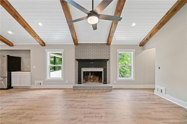 136 Ridgecrest Dr, Ball Ground, GA 30107 - unfurnished living room featuring beamed ceiling, light wood-style flooring, a brick fireplace, baseboards, and a ceiling fan