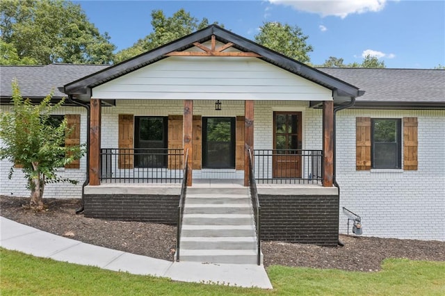 136 Ridgecrest Dr, Ball Ground, GA 30107 - bungalow featuring a porch, brick siding, and roof with shingles