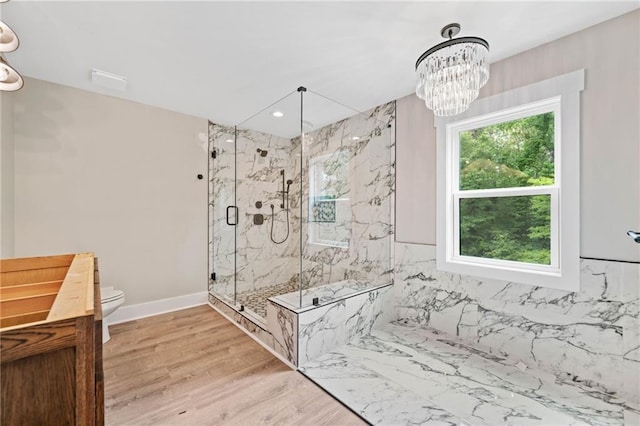 136 Ridgecrest Dr, Ball Ground, GA 30107 - full bath with a marble finish shower, toilet, wood finished floors, a chandelier, and baseboards