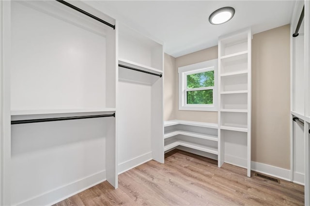 136 Ridgecrest Dr, Ball Ground, GA 30107 - spacious closet featuring light wood-style flooring and a barn door