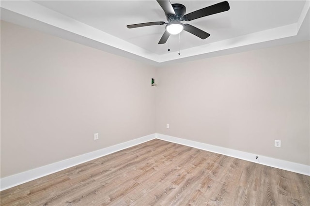 136 Ridgecrest Dr, Ball Ground, GA 30107 - spare room featuring a raised ceiling, light wood-style flooring, baseboards, and ceiling fan