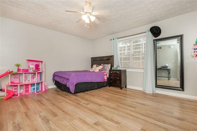 365 Winding River Dr Unit # E, Atlanta, GA 30350 - bedroom with wood finished floors, a textured ceiling, baseboards, and a ceiling fan