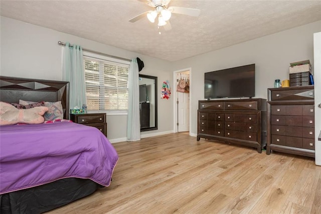 365 Winding River Dr Unit # E, Atlanta, GA 30350 - bedroom featuring wood finished floors, a textured ceiling, baseboards, and ceiling fan