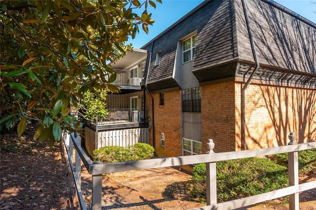 365 Winding River Dr Unit # E, Atlanta, GA 30350 - view of home's exterior featuring brick siding, mansard roof, and roof with shingles