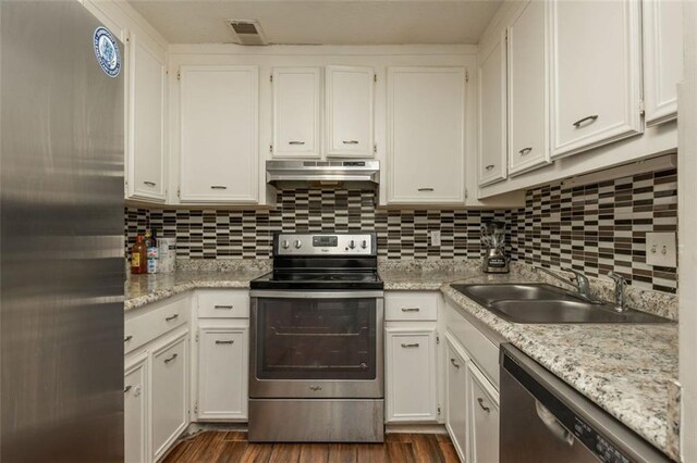 365 Winding River Dr Unit # E, Atlanta, GA 30350 - kitchen with stainless steel appliances, range hood, a sink, white cabinetry, and decorative backsplash
