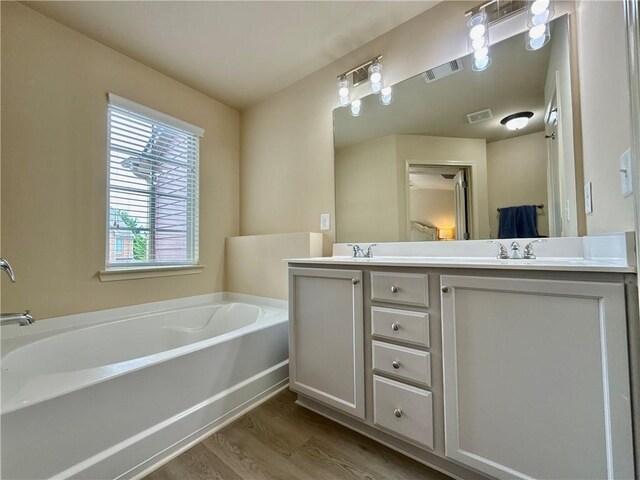 2351 Attewood Dr, Buford, GA 30519 - full bath featuring wood finished floors, double vanity, and a bath