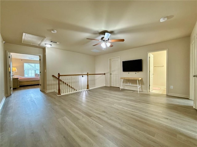 2351 Attewood Dr, Buford, GA 30519 - unfurnished living room with attic access, wood finished floors, a ceiling fan, and baseboards