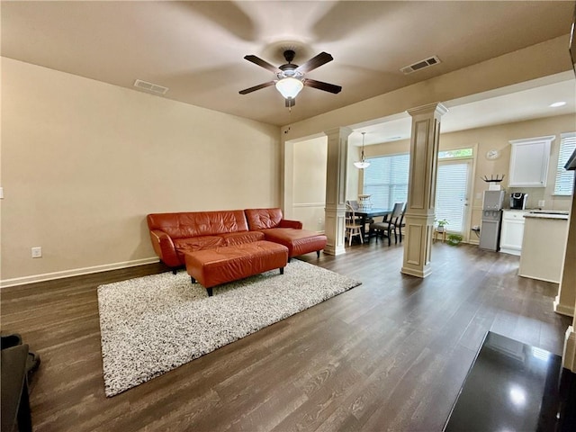 2351 Attewood Dr, Buford, GA 30519 - living room with decorative columns, a ceiling fan, dark wood-style flooring, and baseboards