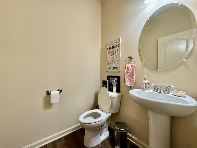 2351 Attewood Dr, Buford, GA 30519 - bathroom with baseboards, wood finished floors, toilet, and a sink
