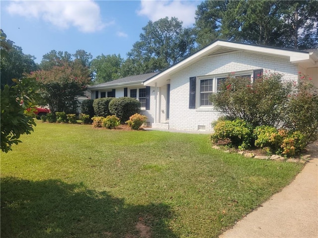 view of side of home featuring a lawn