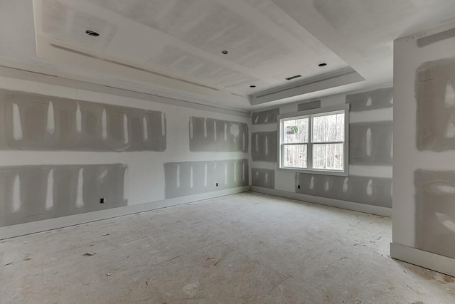 spare room with a raised ceiling