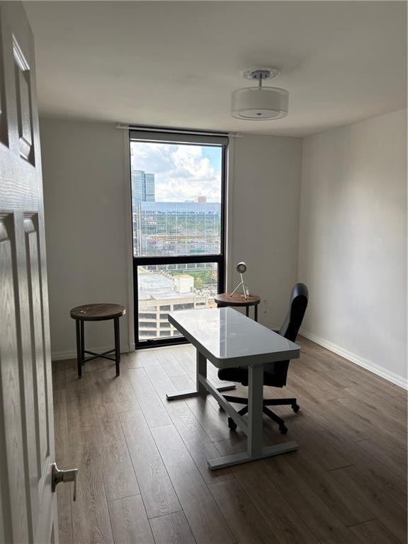 1280 W Peachtree St NW Unit 2409, Atlanta, GA 30309 - office space featuring wood finished floors, baseboards, and floor to ceiling windows