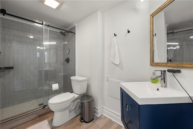 1280 W Peachtree St NW Unit 2409, Atlanta, GA 30309 - full bathroom featuring toilet, vanity, wood finished floors, a tile shower, and baseboards