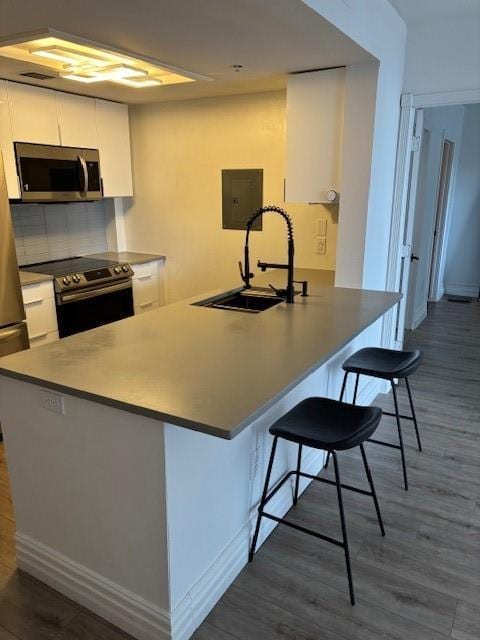 1280 W Peachtree St NW Unit 2409, Atlanta, GA 30309 - kitchen with stainless steel appliances, a sink, and white cabinets