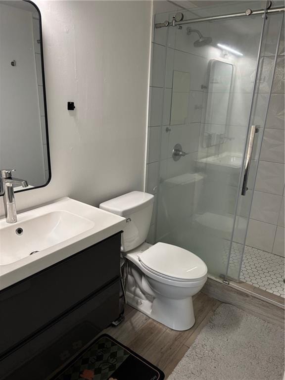 1280 W Peachtree St NW Unit 2409, Atlanta, GA 30309 - bathroom with wood finished floors, toilet, vanity, and a shower stall