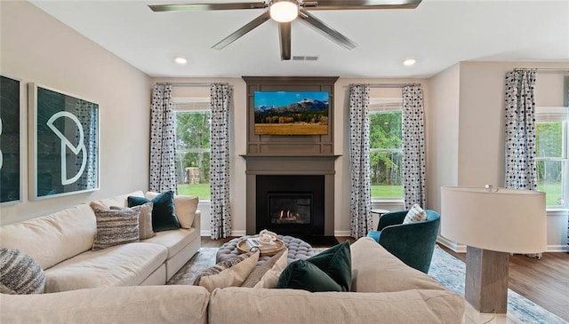 living area featuring a ceiling fan, wood finished floors, healthy amount of natural light, and recessed lighting