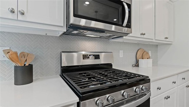 kitchen featuring appliances with stainless steel finishes, tasteful backsplash, light countertops, and white cabinets