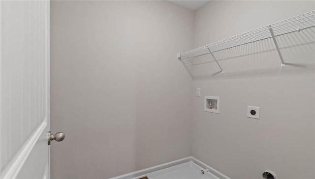 laundry area with hookup for a washing machine, electric dryer hookup, and baseboards
