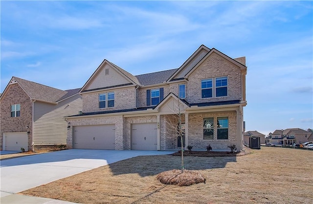 craftsman house with brick siding, a garage, and driveway