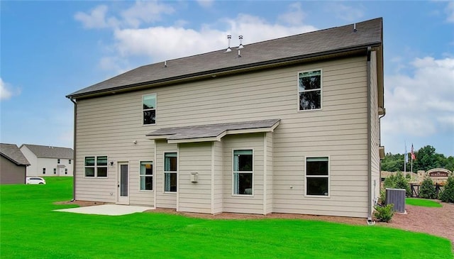 back of property with a yard, central AC, and a patio