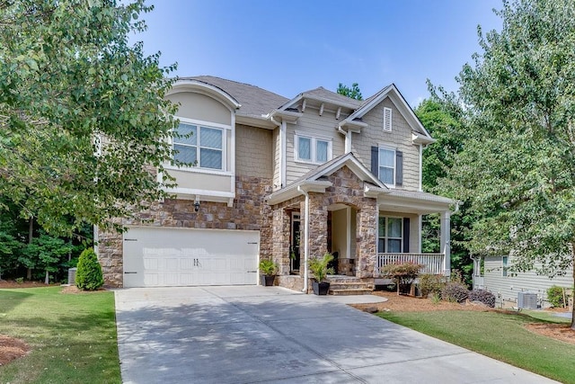 craftsman-style home with a porch, a garage, and a front lawn