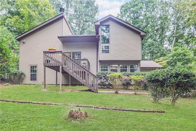 back of house with a wooden deck, stairs, and a yard