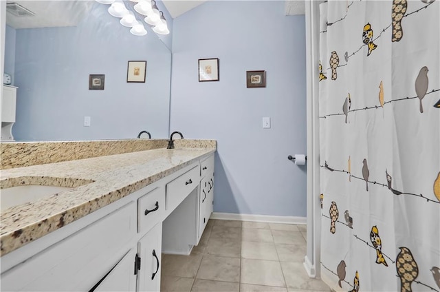 full bath with double vanity, baseboards, visible vents, tile patterned floors, and a sink