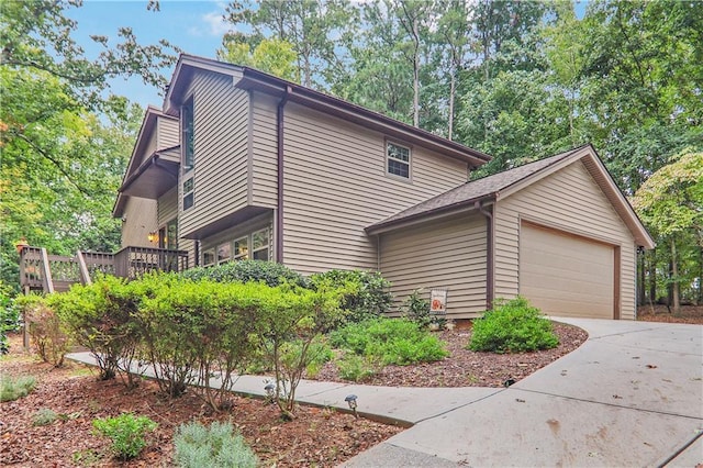 view of home's exterior with an attached garage and driveway