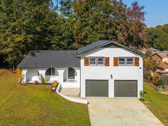 tri-level home with a garage and a front lawn