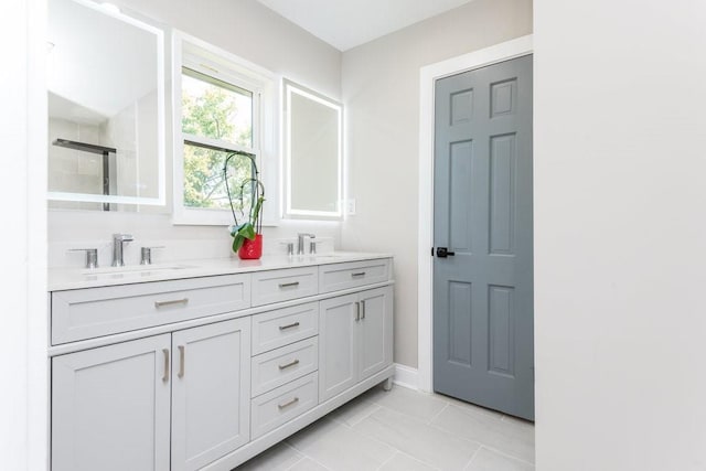 bathroom featuring tile patterned flooring and vanity