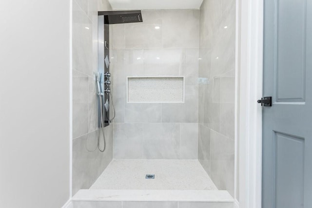 bathroom with tiled shower