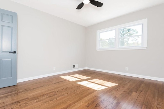 empty room with ceiling fan and hardwood / wood-style flooring