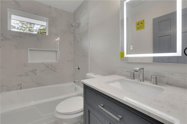 full bathroom with tiled shower / bath combo, toilet, and vanity