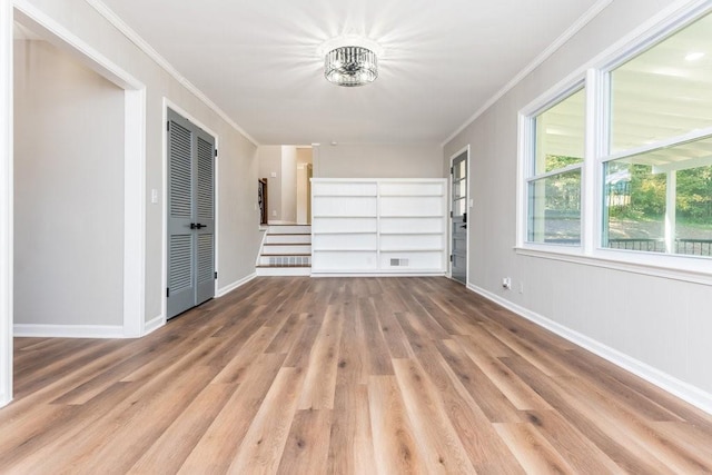 interior space with ornamental molding and light hardwood / wood-style flooring