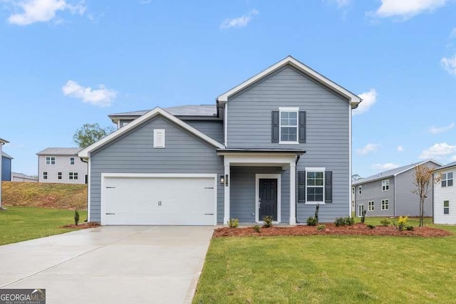 traditional-style home featuring a garage, driveway, and a front lawn