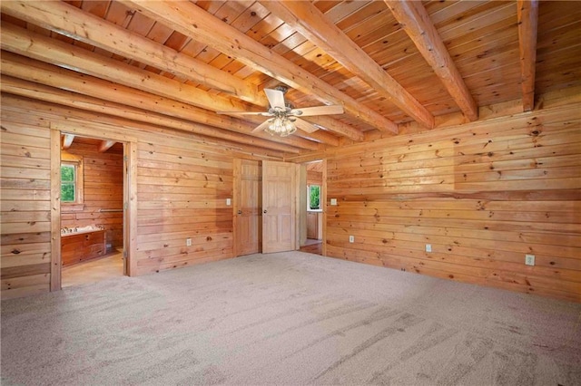 spare room with carpet flooring, ceiling fan, wooden ceiling, and beam ceiling