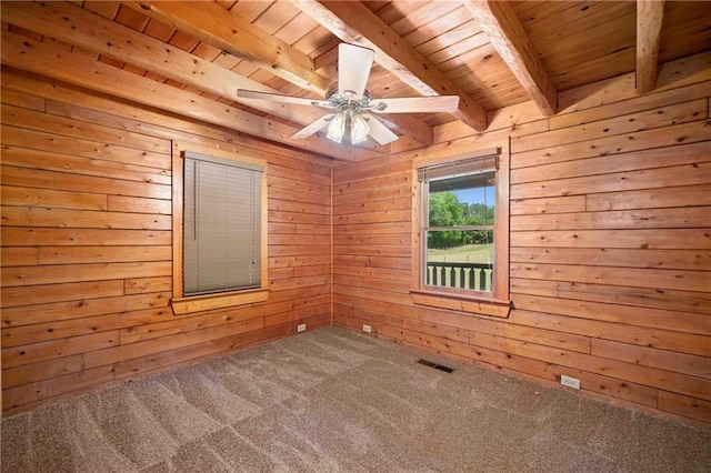 empty room featuring wood ceiling, carpet, beam ceiling, and visible vents