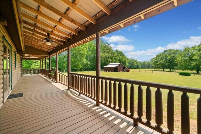deck with an outdoor structure and a yard