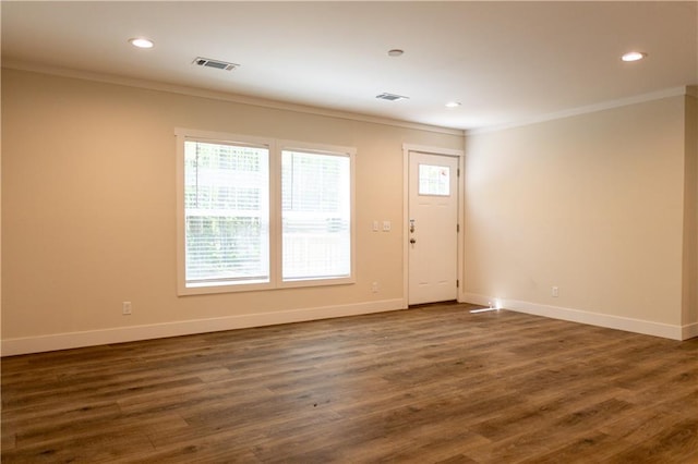 spare room featuring recessed lighting, baseboards, visible vents, and ornamental molding