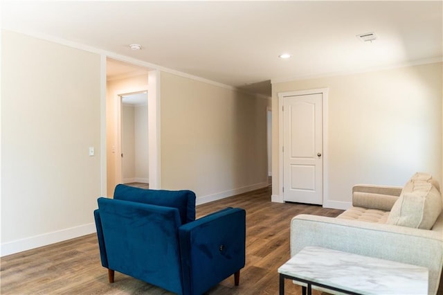 sitting room with crown molding, baseboards, and wood finished floors