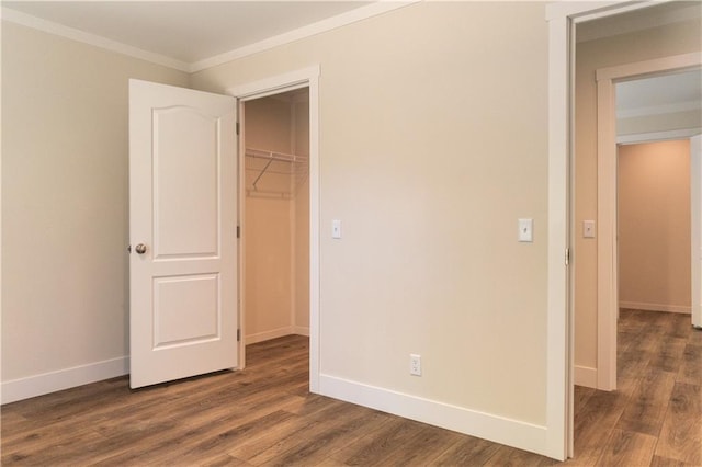 unfurnished bedroom featuring baseboards, ornamental molding, and dark wood-style flooring
