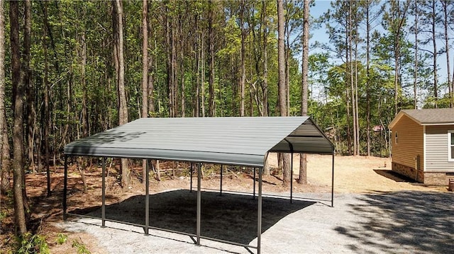 exterior space featuring a wooded view and a carport