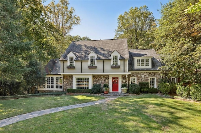 view of front of house featuring stone siding and a front yard