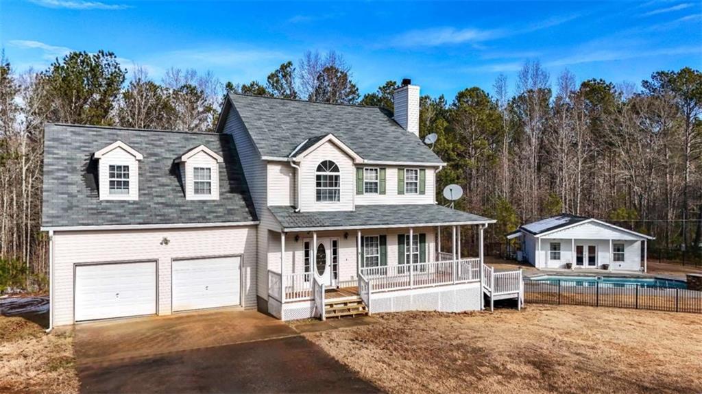 view of front of home featuring a garage and a porch