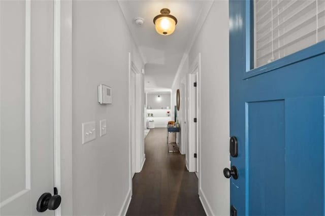 hallway with dark wood-style flooring and baseboards